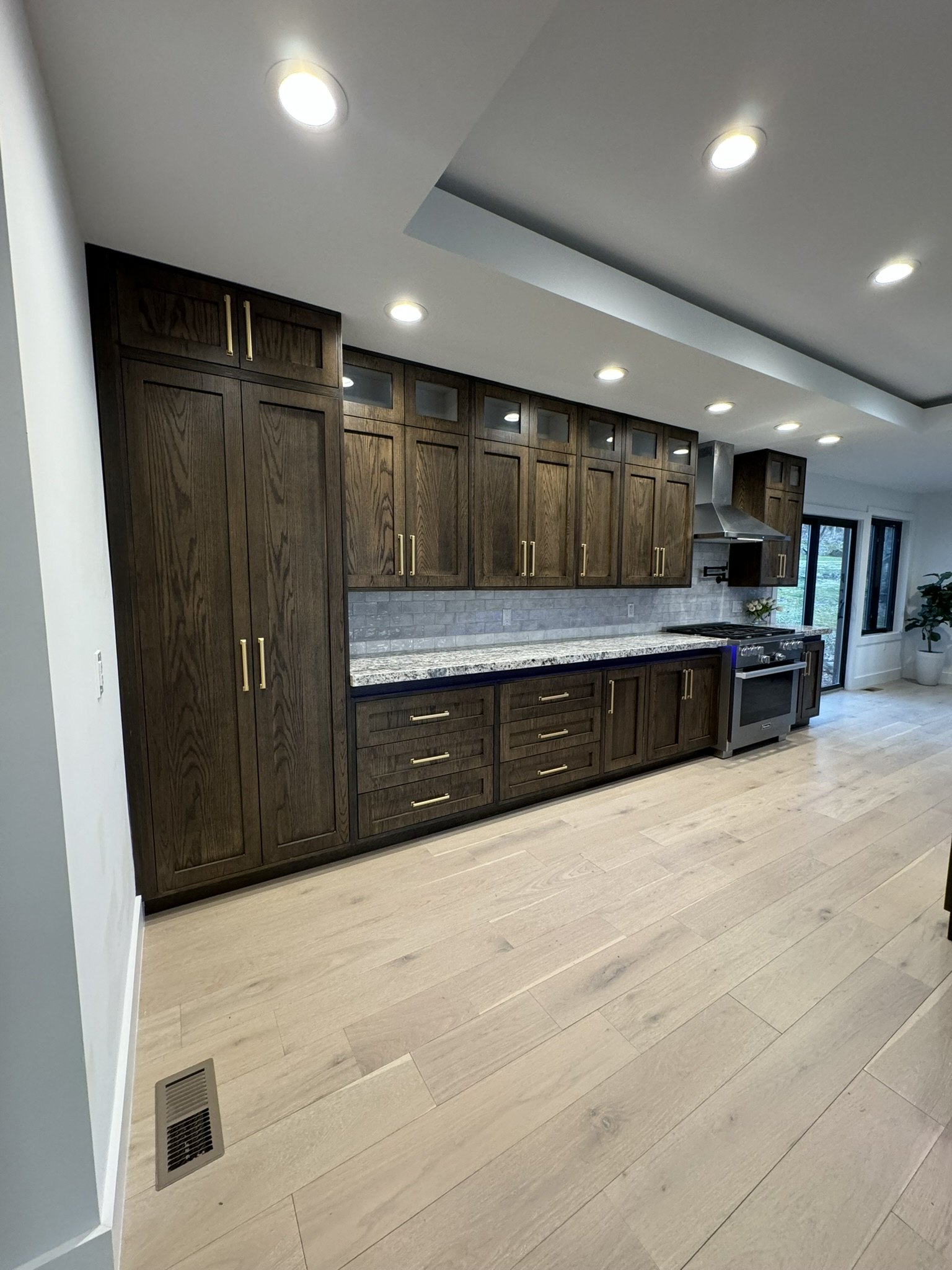 Dark oak shaker pantry wall and kitchen with brass pulls, CNC-cut in Newark, NJ by X-Trim